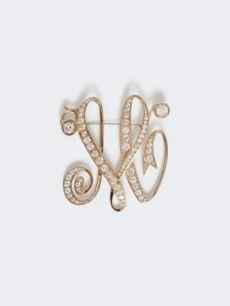 Broche con monograma y pedrería, color marfil