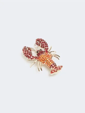Broche de metal con pedrería, rojo oscuro